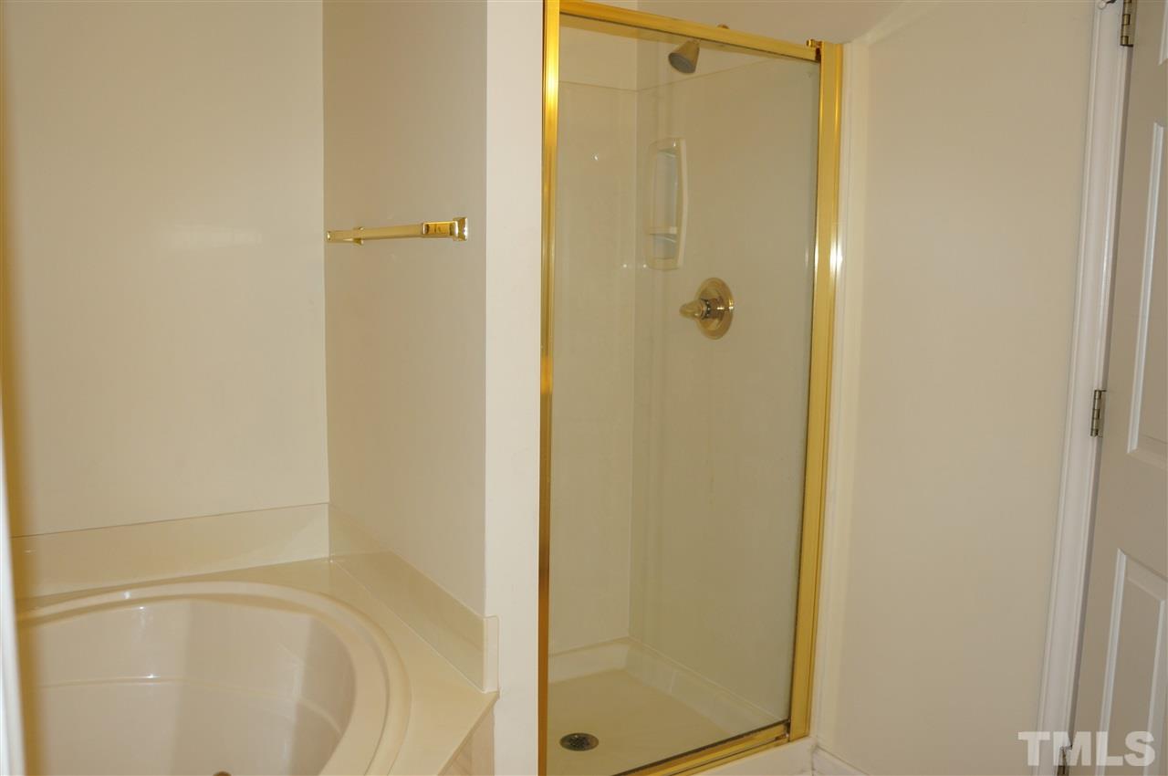 508 South Person Street, Unit 107 Raleigh, NC 27601 - Photo 21 of 24 a bathroom with a glass shower door