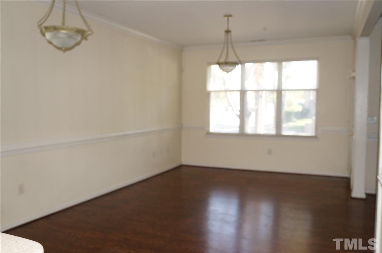 508 South Person Street, Unit 107 Raleigh, NC 27601 - Photo 10 of 24 an empty room with wooden floor and windows