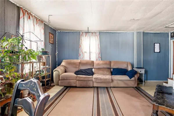 a living room with furniture fireplace and a window