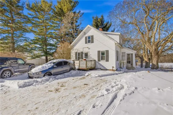 a view of a house with a yard covered in snow