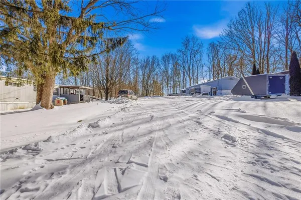 a view of a house with snow on the road