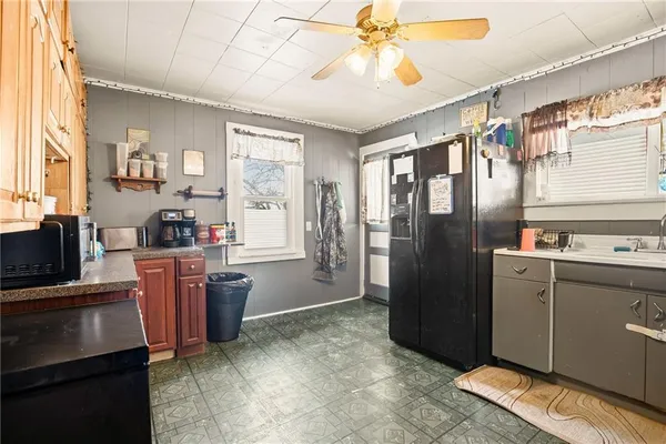 a kitchen with stainless steel appliances granite countertop a refrigerator and a sink