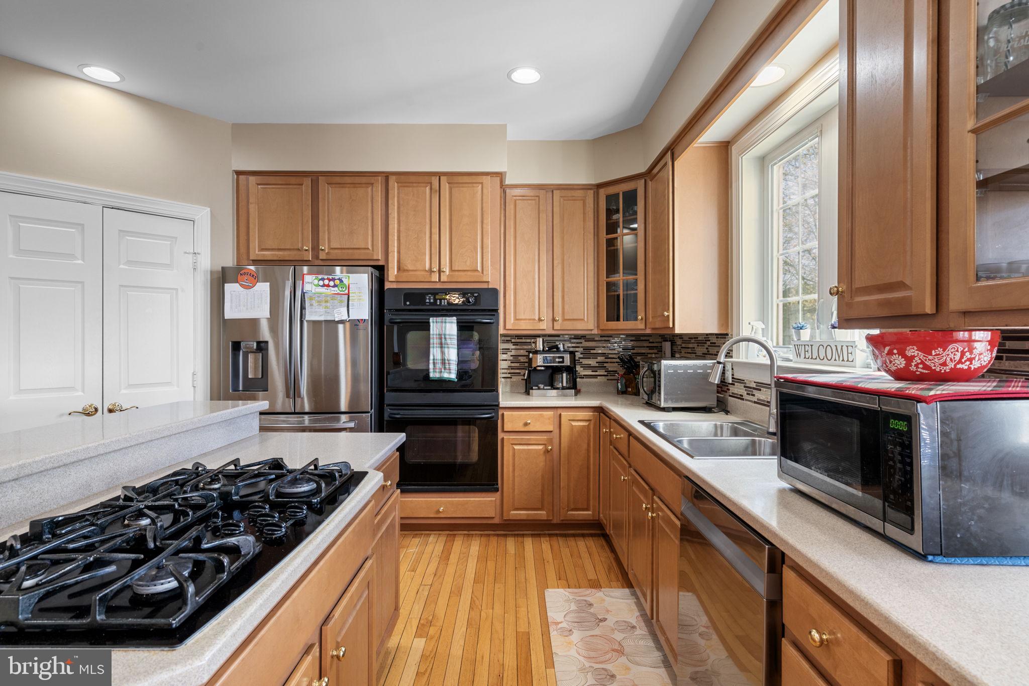 4016 Sapling Way Triangle, VA 22172 - Photo 16 of 56 a kitchen with stove a sink and cabinets