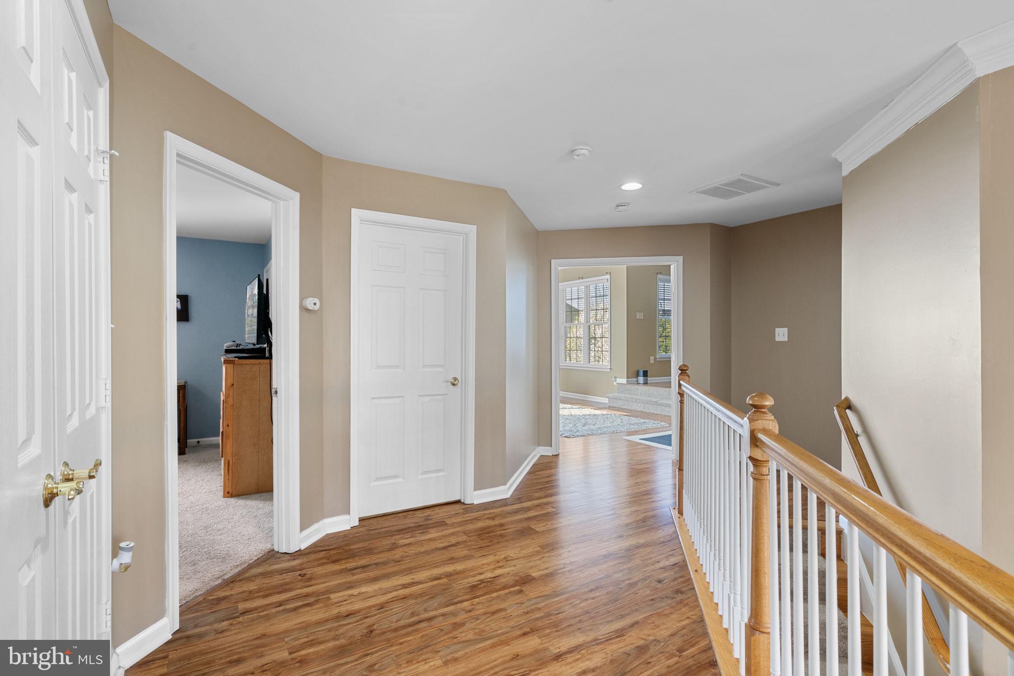 4016 Sapling Way Triangle, VA 22172 - Photo 19 of 56 a view of a hallway with wooden floor and staircase