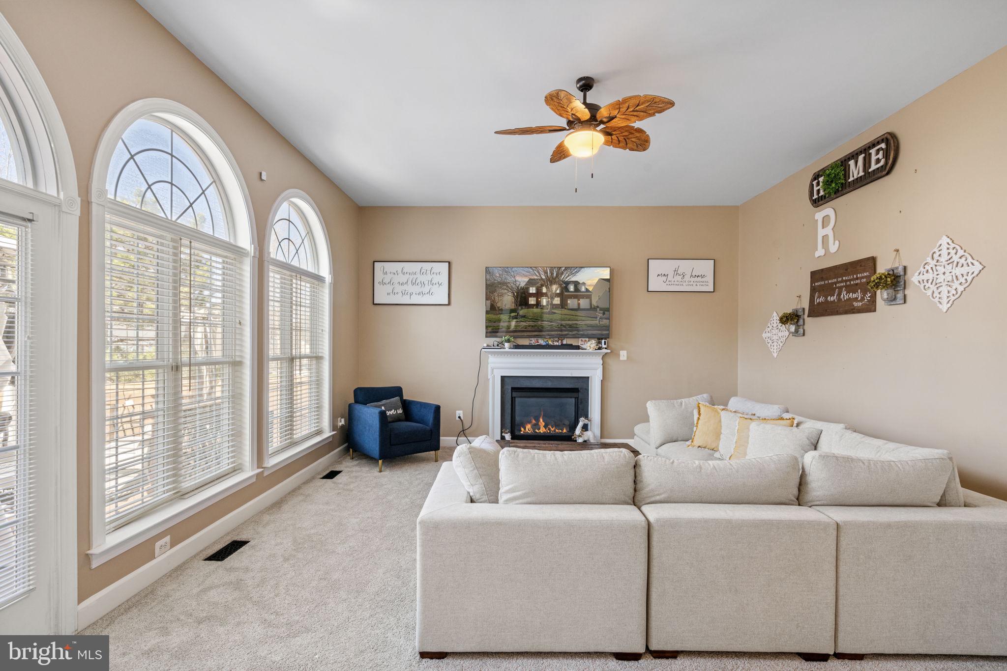 4016 Sapling Way Triangle, VA 22172 - Photo 20 of 56 a living room with furniture and a fireplace