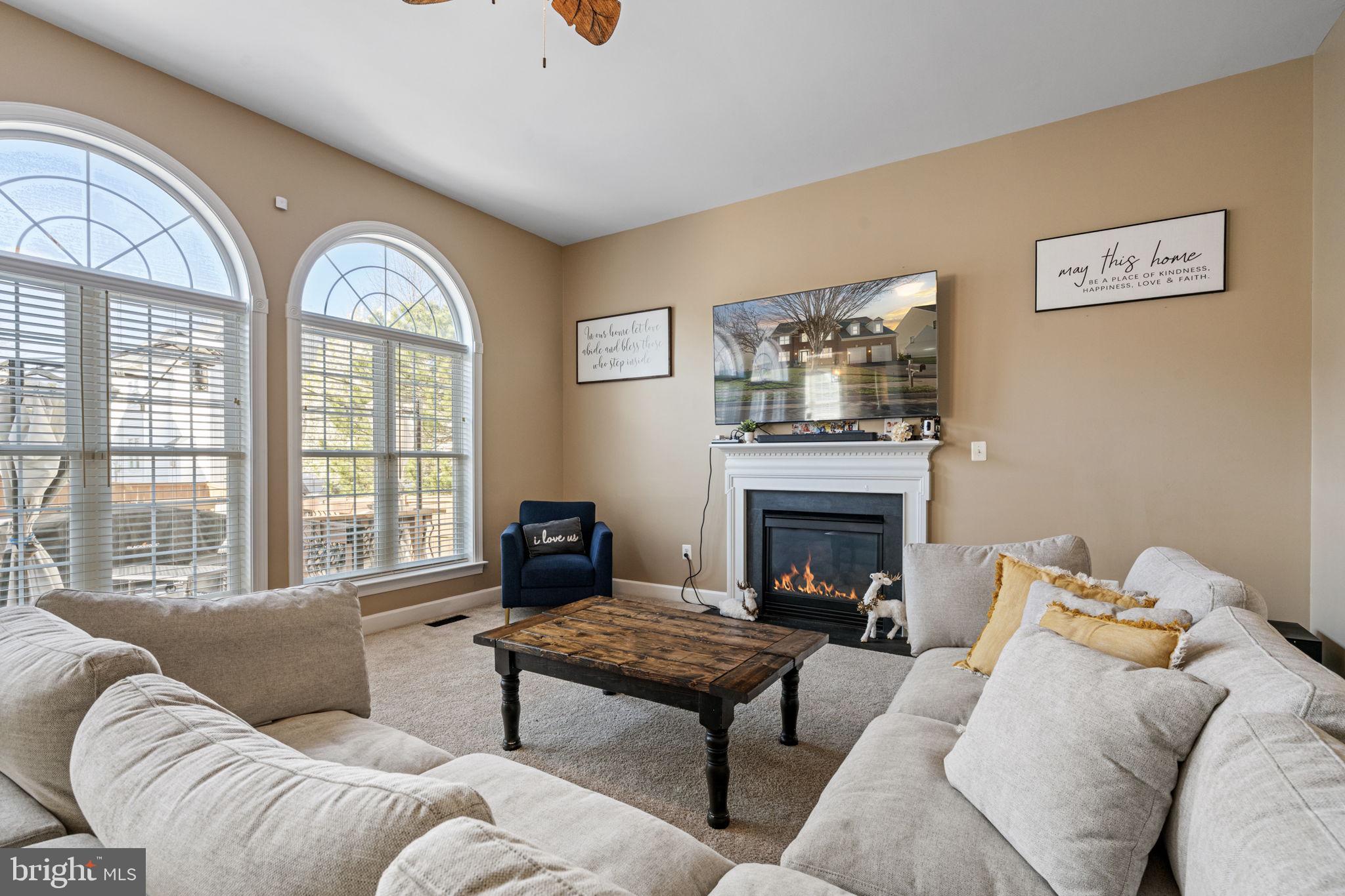 4016 Sapling Way Triangle, VA 22172 - Photo 22 of 56 a living room with furniture fireplace and a large window