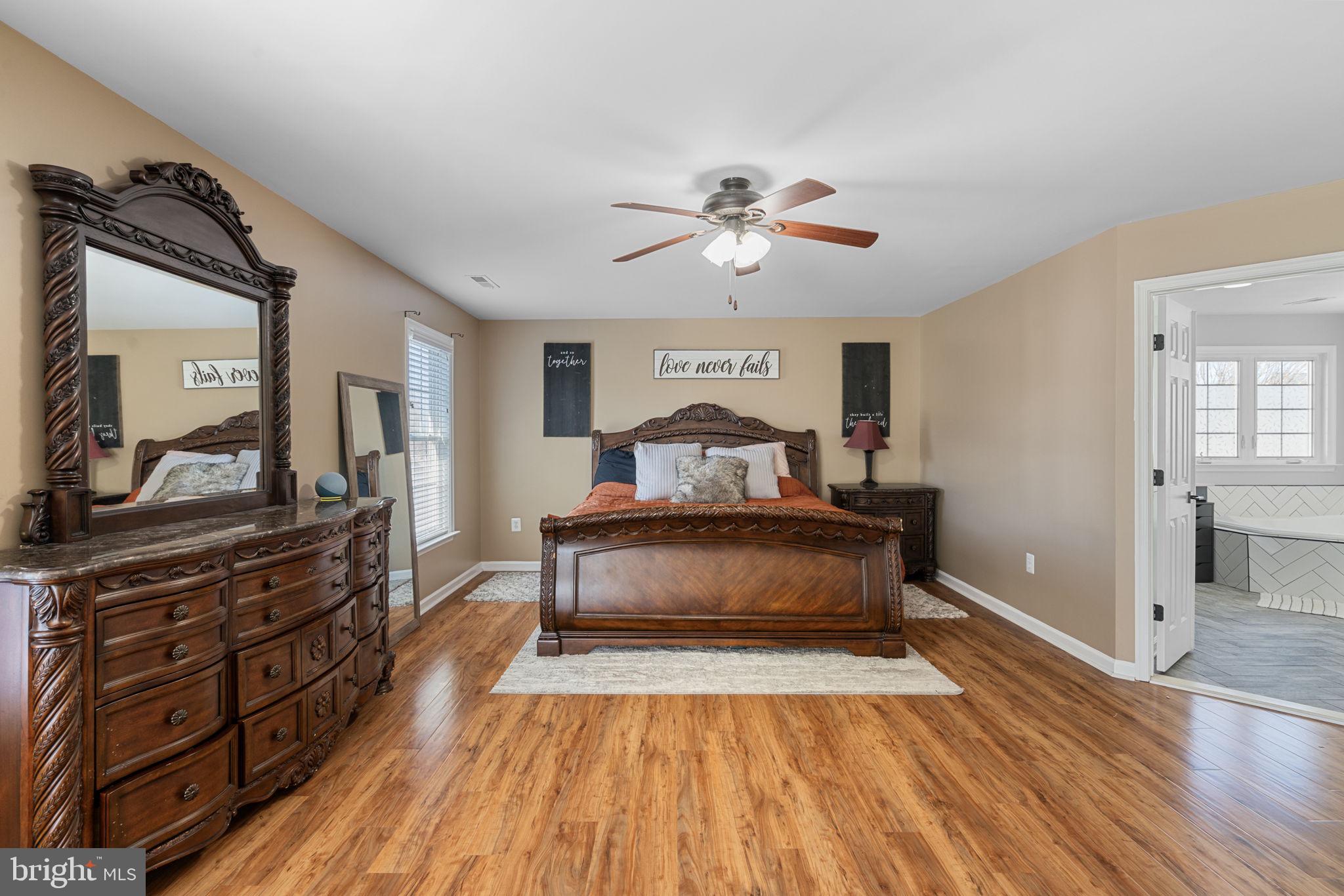 4016 Sapling Way Triangle, VA 22172 - Photo 27 of 56 a bedroom with a bed and wooden floor