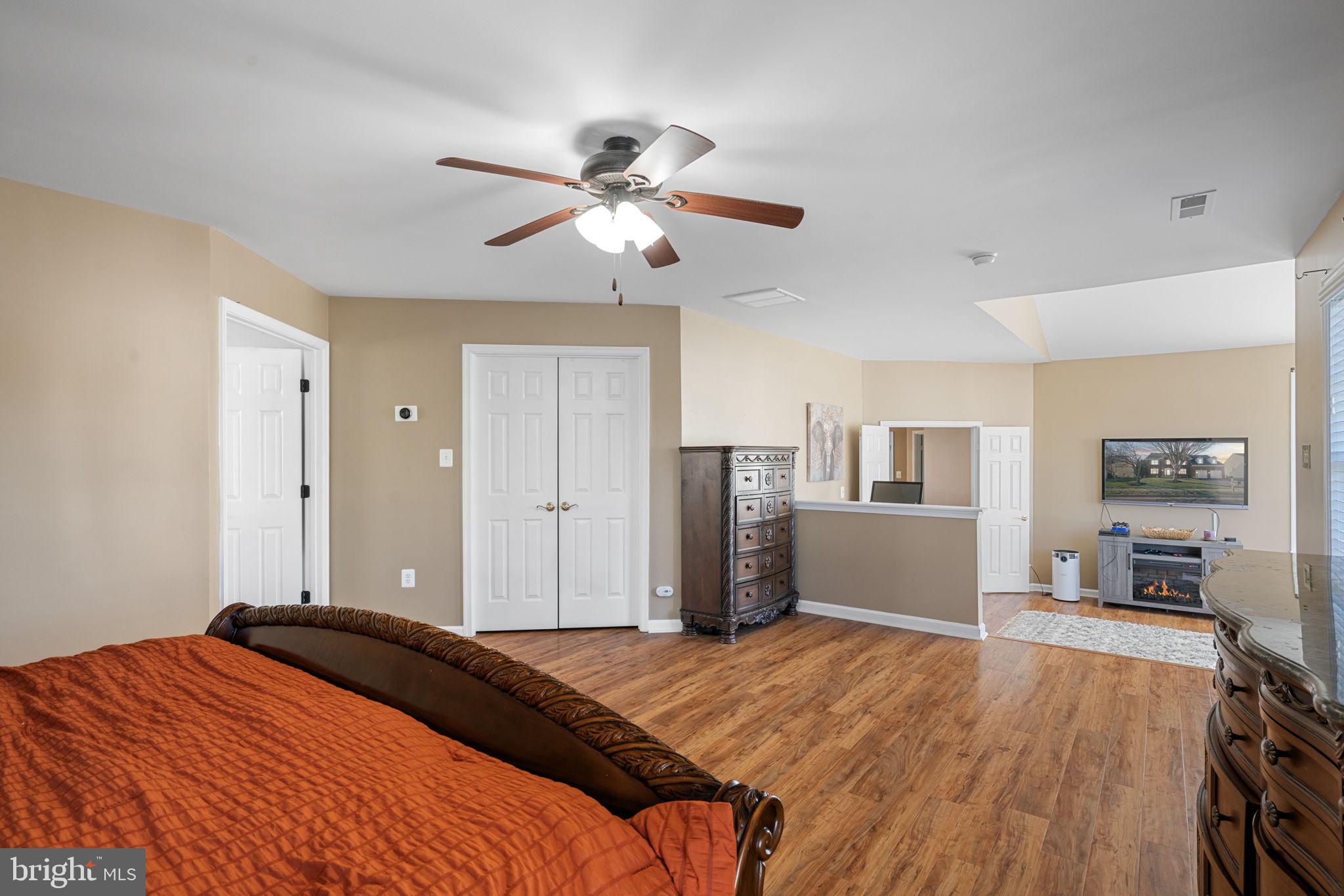 4016 Sapling Way Triangle, VA 22172 - Photo 28 of 56 a bedroom with a bed and a chandelier