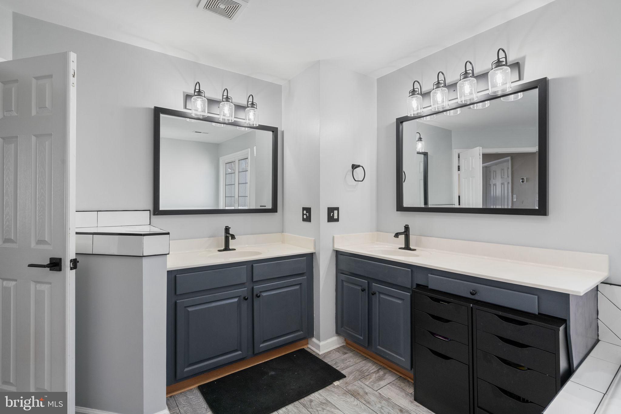 4016 Sapling Way Triangle, VA 22172 - Photo 30 of 56 a bathroom with a double vanity sink and mirror