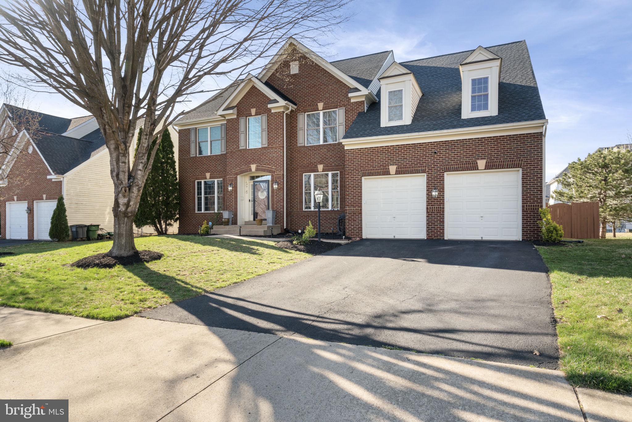 4016 Sapling Way Triangle, VA 22172 - Photo 3 of 56 a front view of a house with a yard