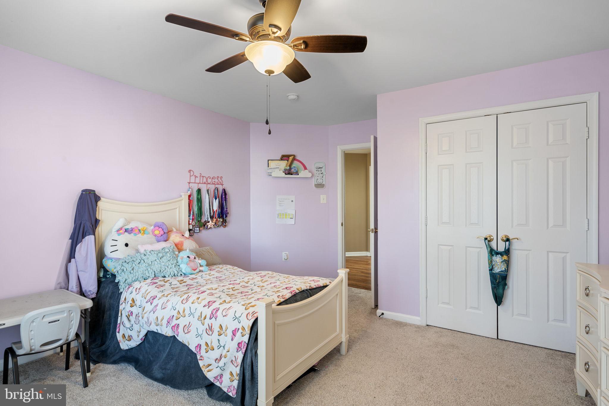 4016 Sapling Way Triangle, VA 22172 - Photo 39 of 56 a bedroom with a bed and a chandelier