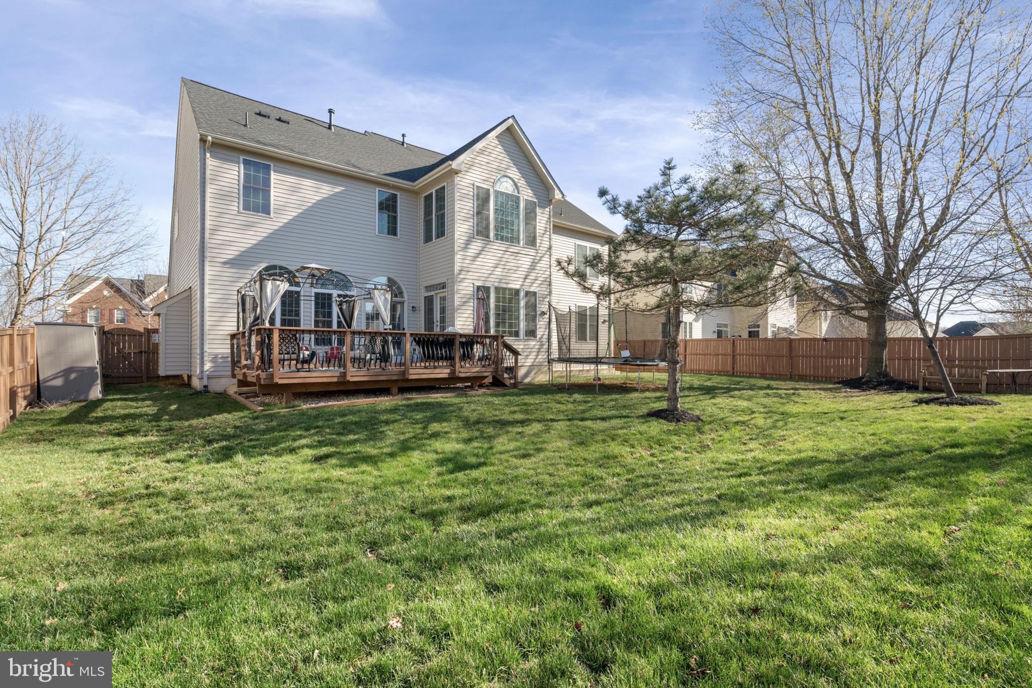4016 Sapling Way Triangle, VA 22172 - Photo 44 of 56 a front view of a house with a yard table and chairs