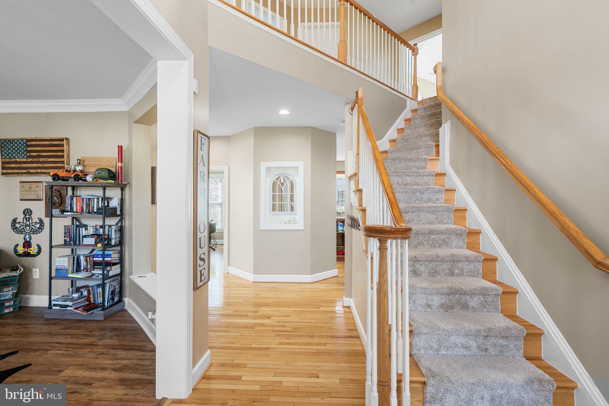 4016 Sapling Way Triangle, VA 22172 - Photo 6 of 56 a view of hallway with stairs and wooden floor
