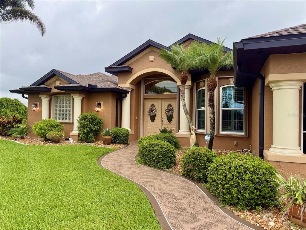 95 Tournament Road Rotonda West, FL 33947 - Photo 1 of 1 a front view of a house with garden