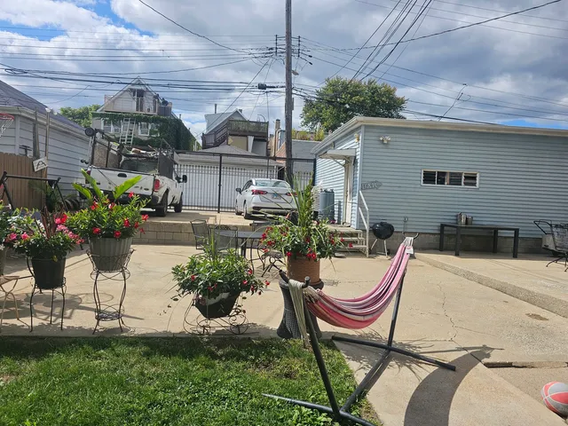 a view of a backyard with plants and a patio