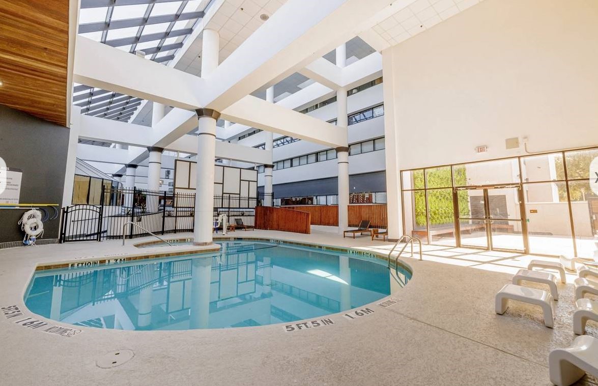14703 Park Row Houston, TX 77079 - Photo 13 of 40 a view of a swimming pool with a lounge chairs
