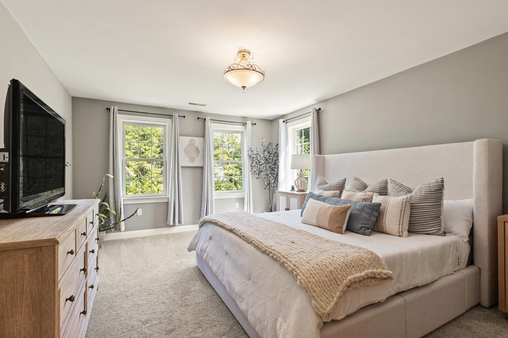 2 Leitner Way Middleton, MA 01949 - Photo 14 of 42 a bedroom with a bed and a flat tv screen on the dresser
