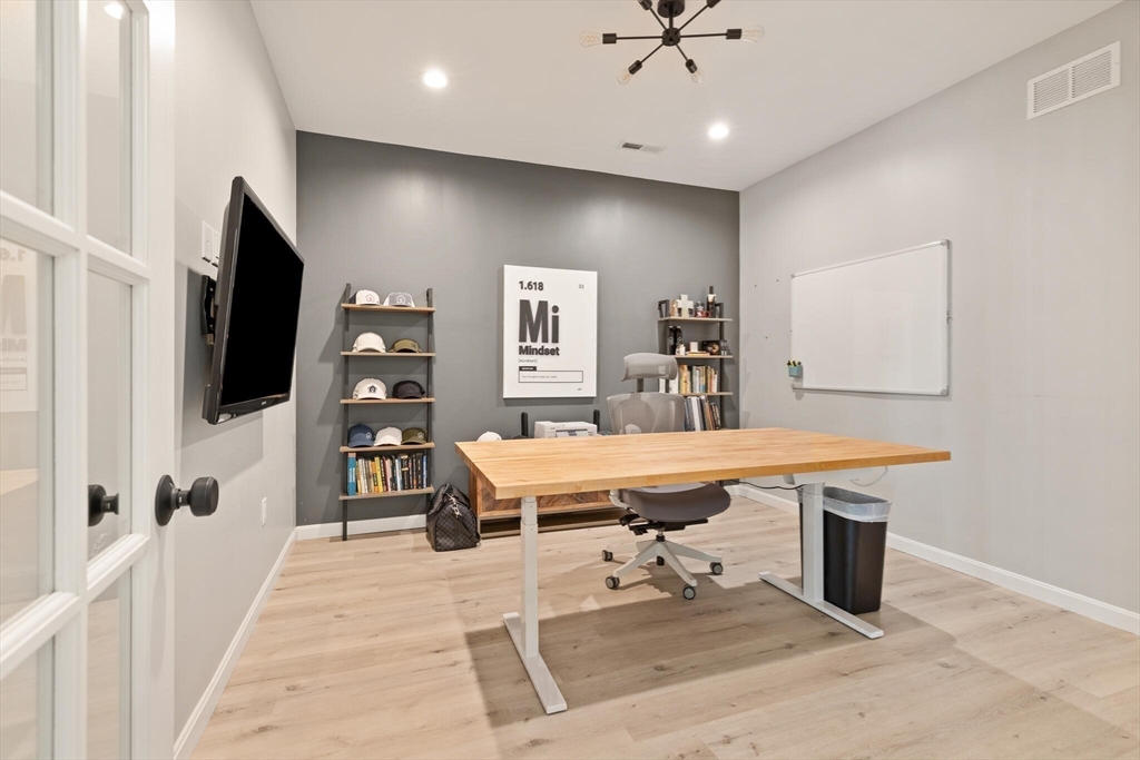 2 Leitner Way Middleton, MA 01949 - Photo 21 of 42 a room with table chairs and flat screen tv