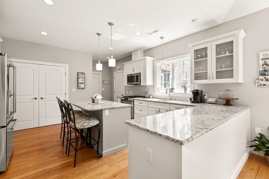 2 Leitner Way Middleton, MA 01949 - Photo 27 of 42 a large kitchen with kitchen island a sink table and chairs