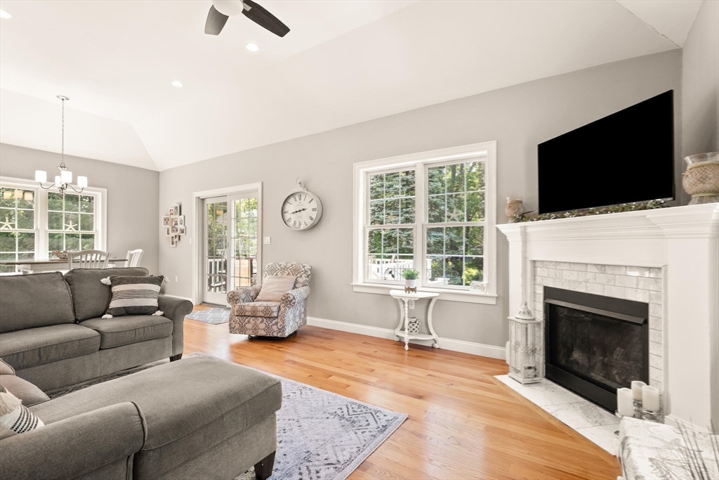 2 Leitner Way Middleton, MA 01949 - Photo 29 of 42 a living room with furniture a fireplace and a flat screen tv