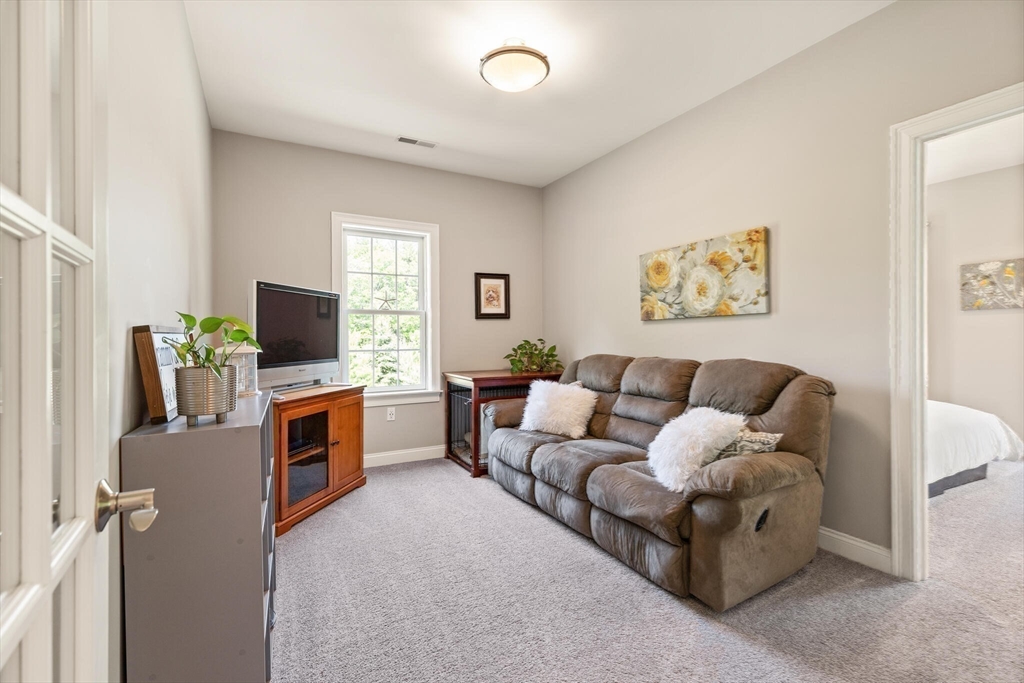 2 Leitner Way Middleton, MA 01949 - Photo 30 of 42 a living room with furniture and a flat screen tv