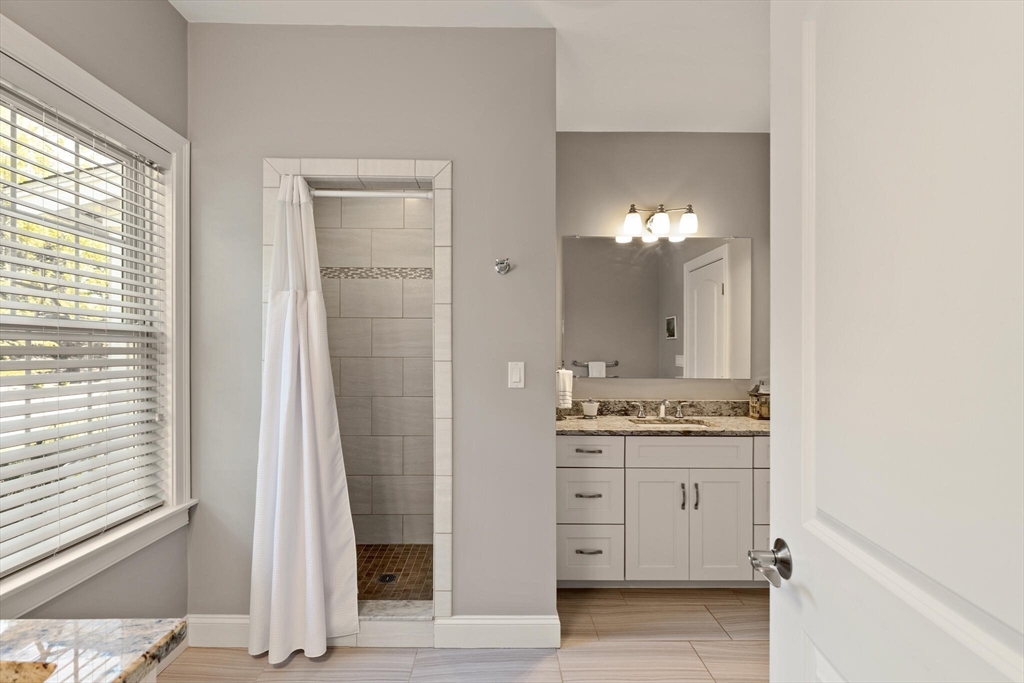 2 Leitner Way Middleton, MA 01949 - Photo 33 of 42 a bathroom with a double vanity sink and mirror with shower