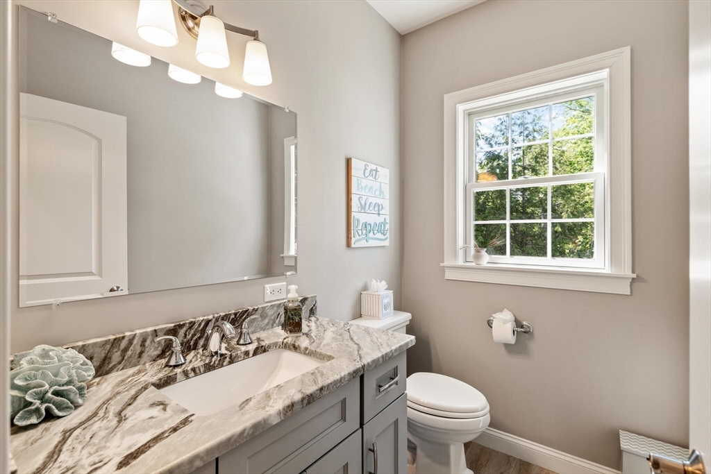 2 Leitner Way Middleton, MA 01949 - Photo 34 of 42 a bathroom with a granite countertop toilet a sink and a mirror