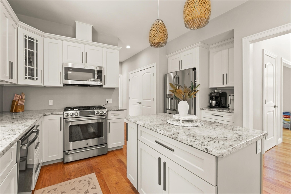 2 Leitner Way Middleton, MA 01949 - Photo 6 of 42 a kitchen with stainless steel appliances granite countertop a stove and cabinets