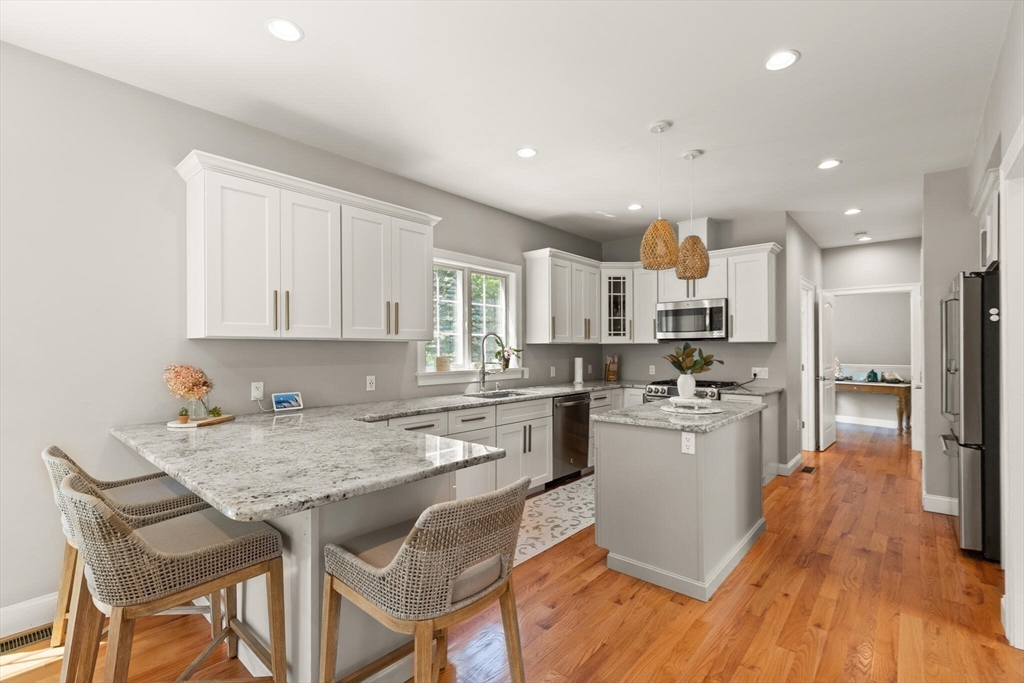 2 Leitner Way Middleton, MA 01949 - Photo 7 of 42 a kitchen with a table chairs refrigerator and cabinets