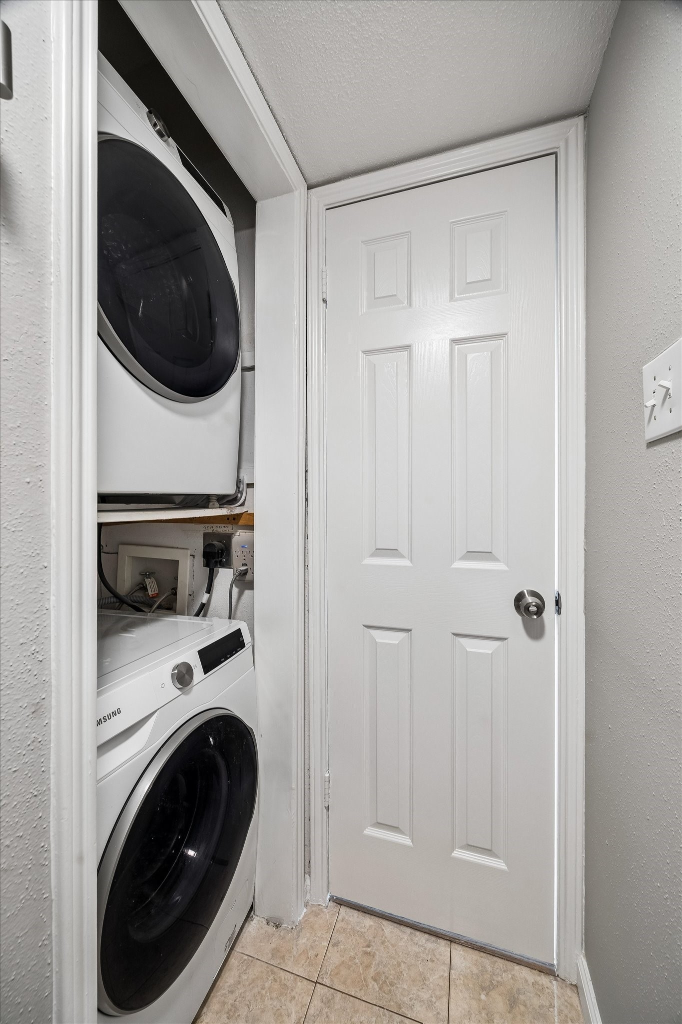 2100 Tanglewilde Street, Unit 702 Houston, TX 77063 - Photo 13 of 19 Stacked Washer and Dryer located upstairs