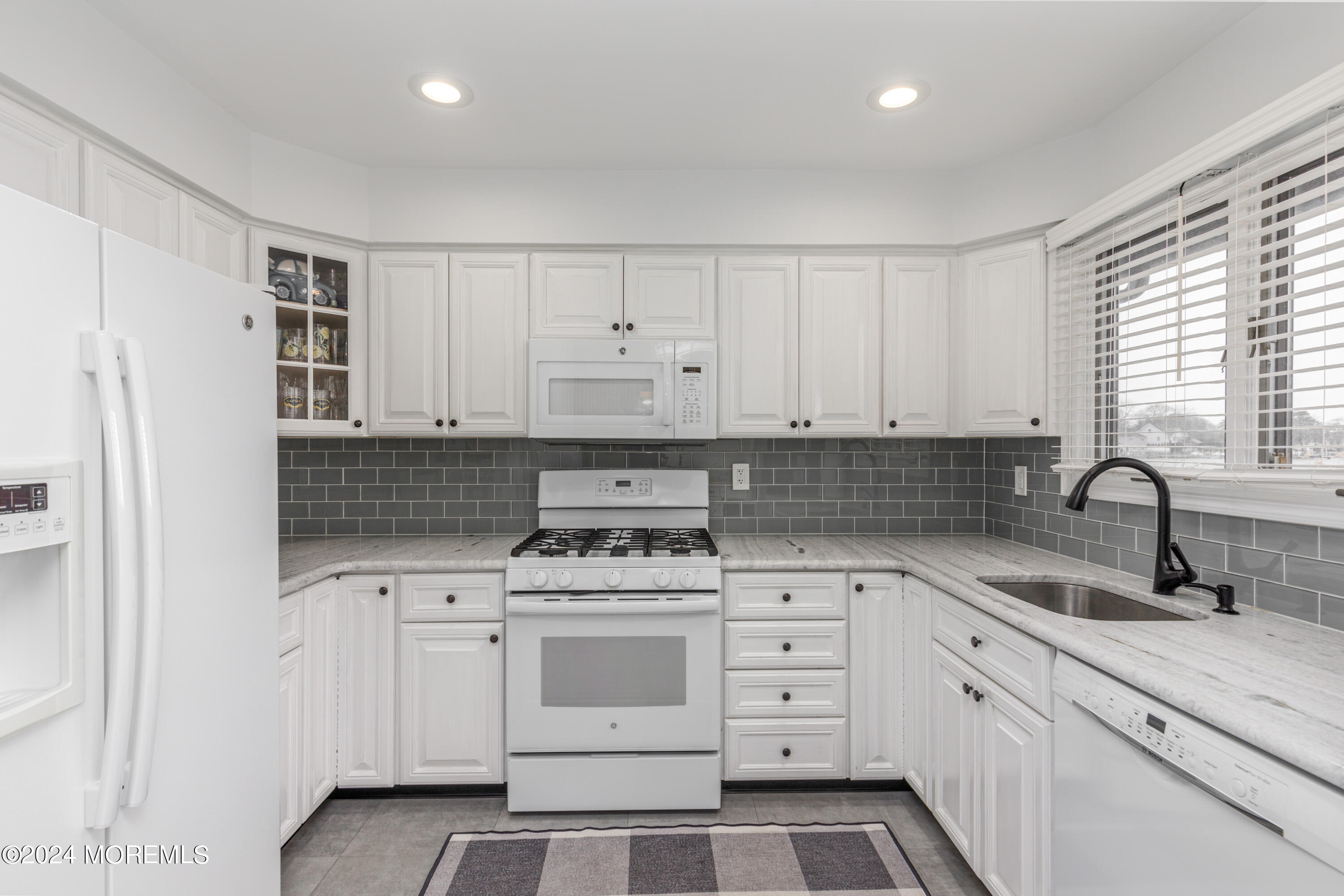 2 Sea Point Drive Point Pleasant, NJ 08742 - Photo 8 of 37 a kitchen with white cabinets appliances and sink