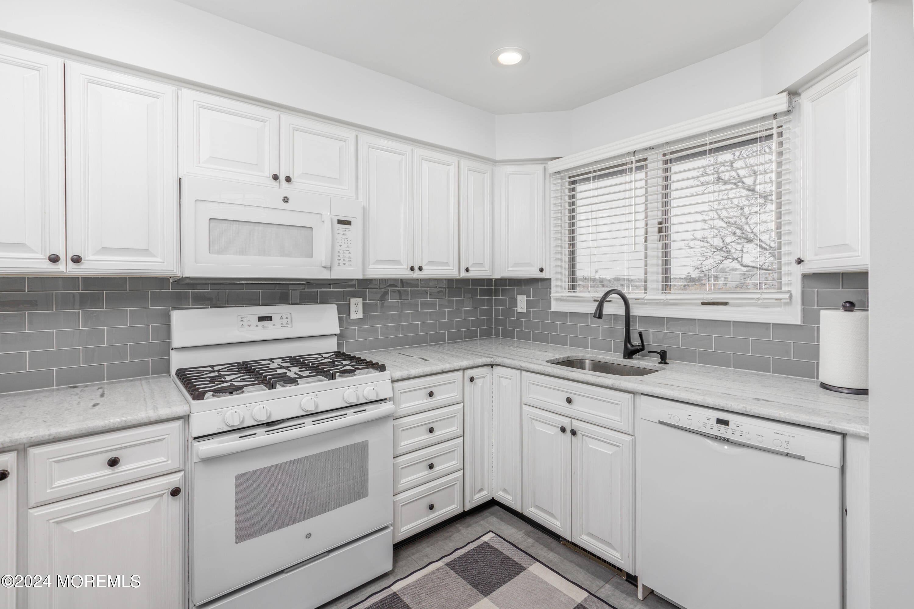 2 Sea Point Drive Point Pleasant, NJ 08742 - Photo 9 of 37 a kitchen with granite countertop white cabinets and white appliances