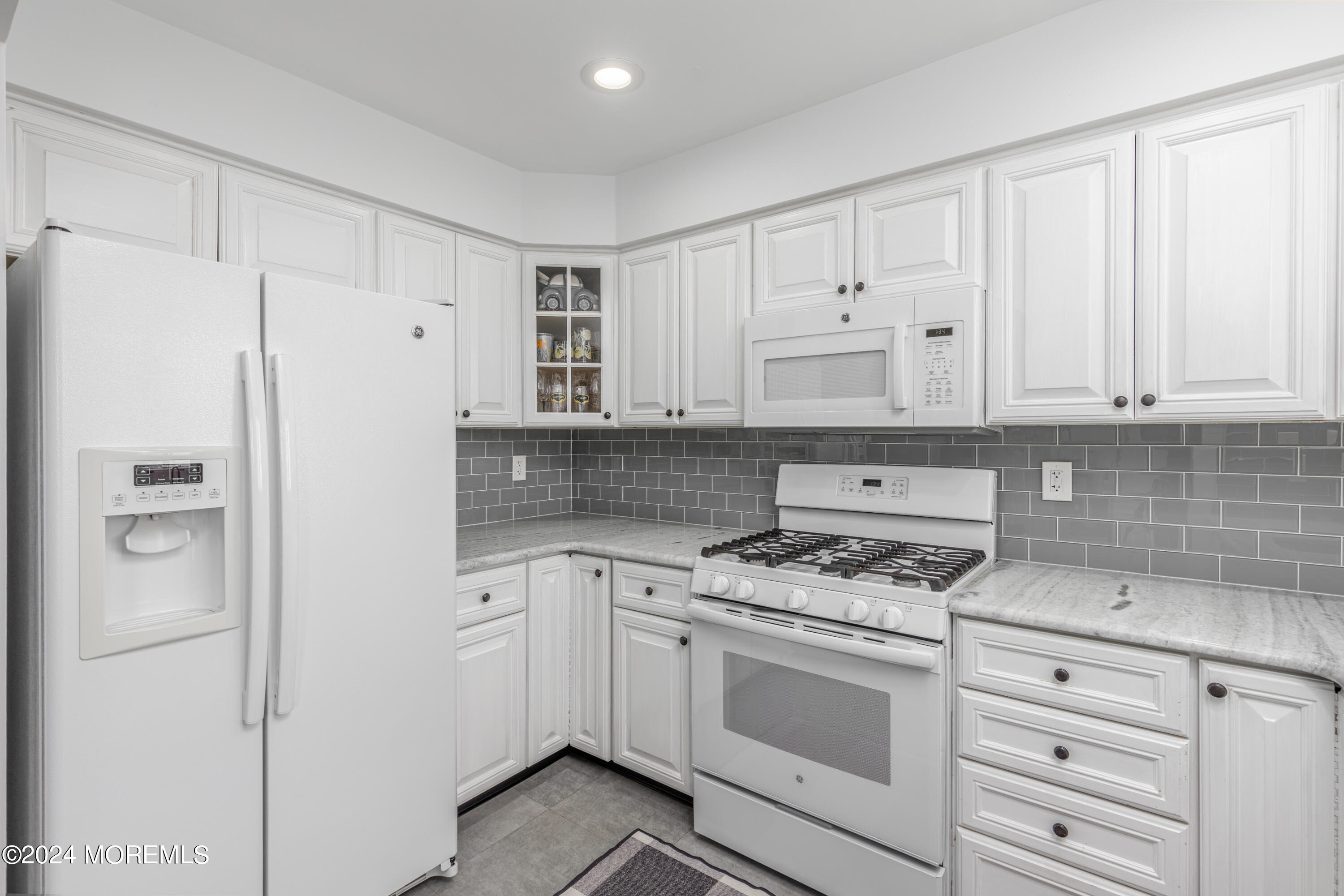 2 Sea Point Drive Point Pleasant, NJ 08742 - Photo 10 of 37 a white kitchen with granite countertop cabinets and refrigerator
