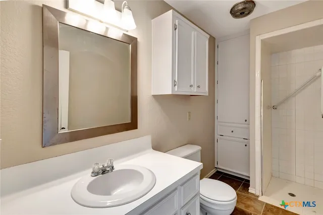 a kitchen with granite countertop white cabinets and window