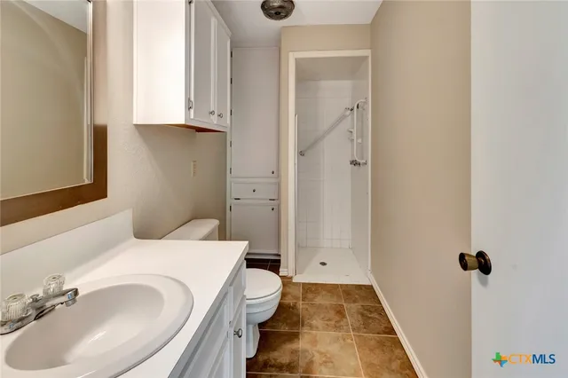 a large kitchen with granite countertop a sink and a stove
