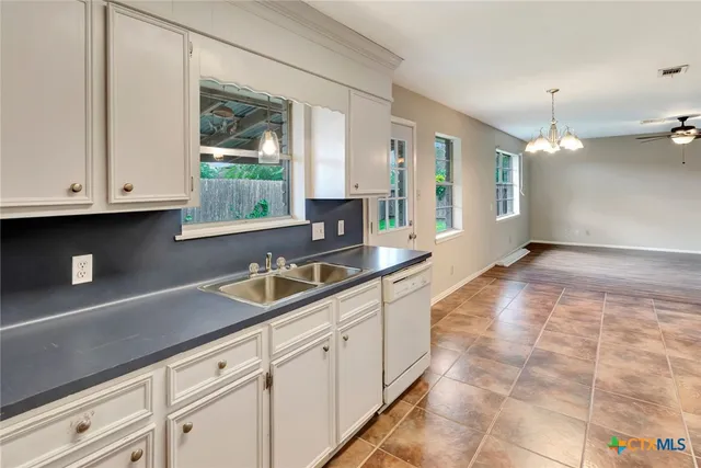 a kitchen with white cabinets and white appliances