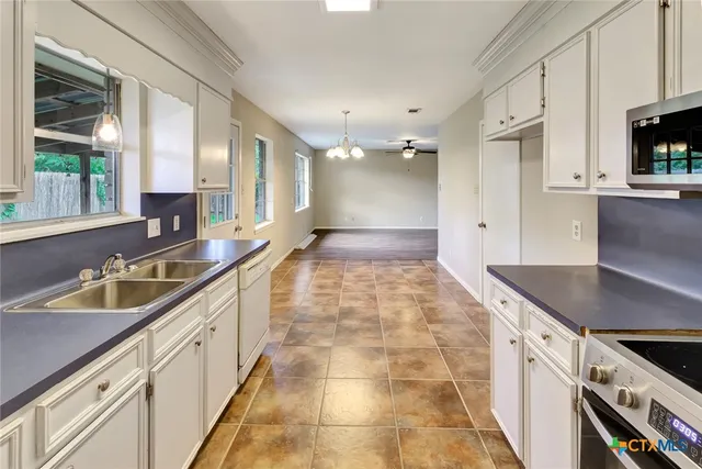 a kitchen with granite countertop a sink and cabinets
