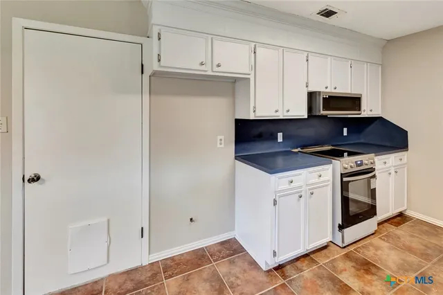 a kitchen with stainless steel appliances a stove a sink and a refrigerator