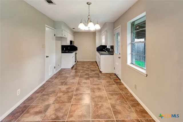 a view of a kitchen with a sink and microwave