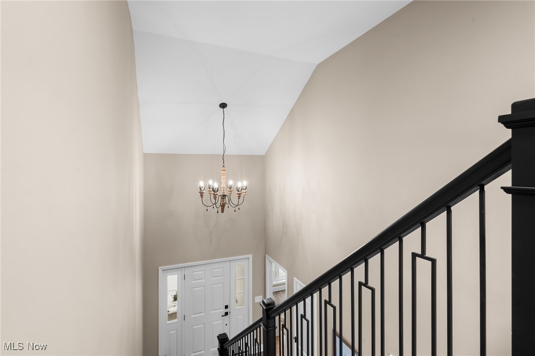 39600 Aurora Road Solon, OH 44139 - Photo 24 of 49 Entrance foyer with stairs, a chandelier, and high vaulted ceiling