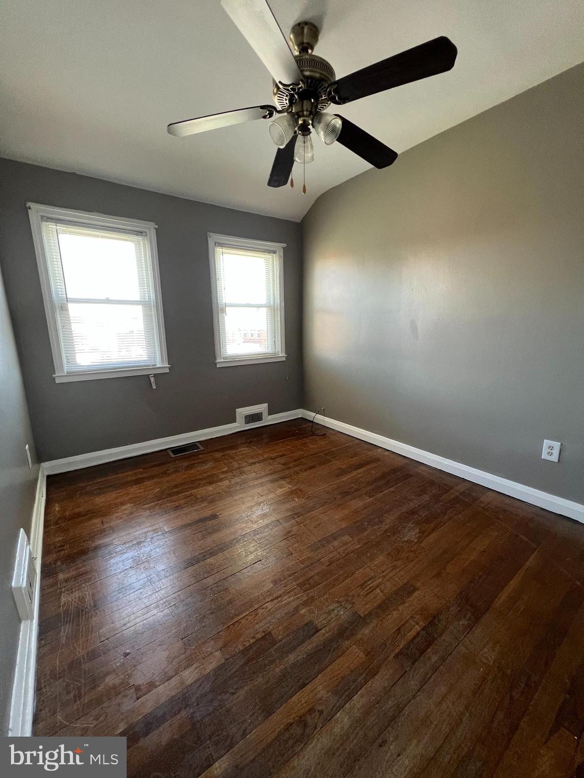 1006 Tunbridge Road Baltimore, MD 21212 - Photo 11 of 19 an empty room with wooden floor fan and windows