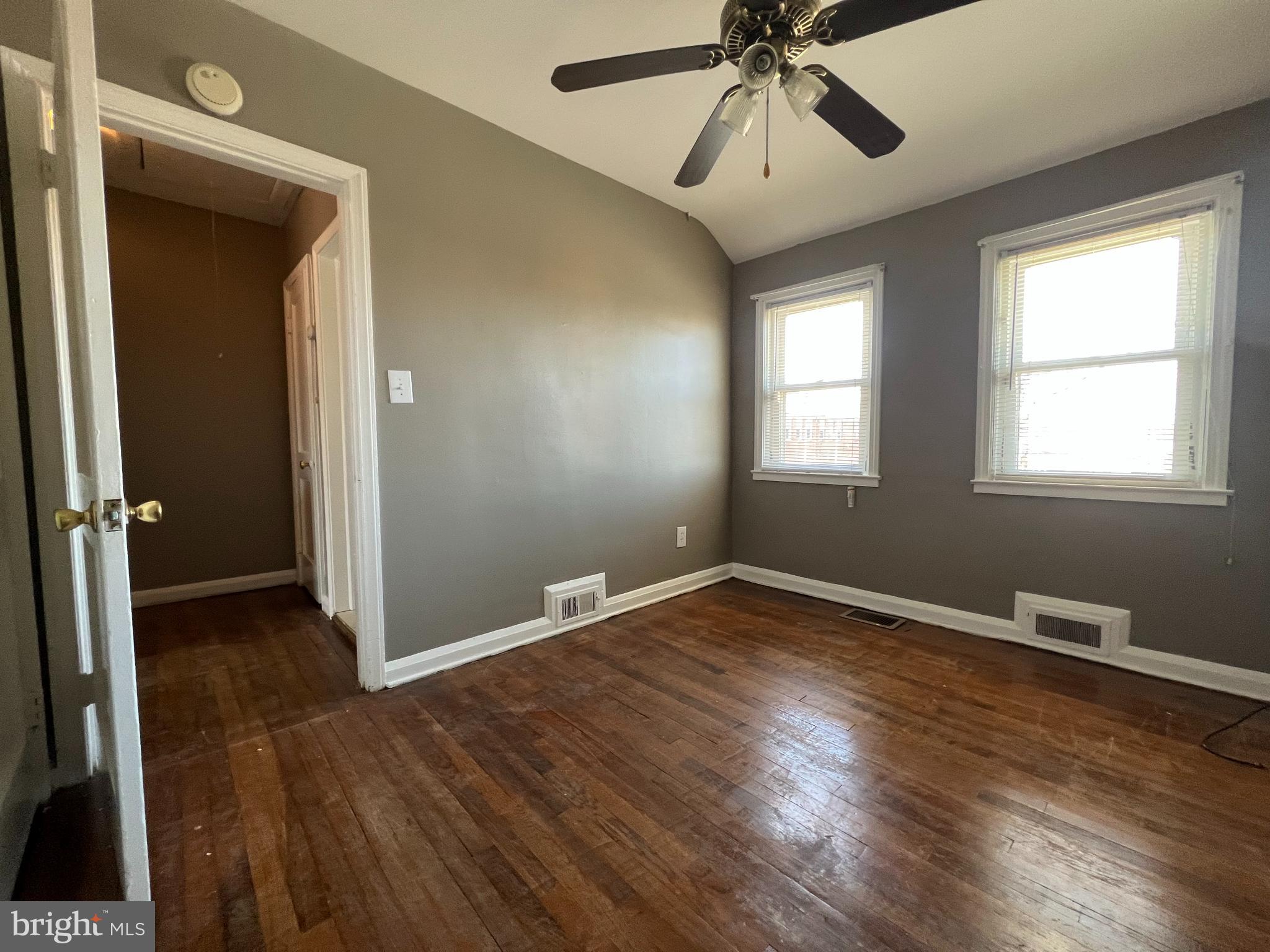 1006 Tunbridge Road Baltimore, MD 21212 - Photo 12 of 19 wooden floor in an empty room with a window