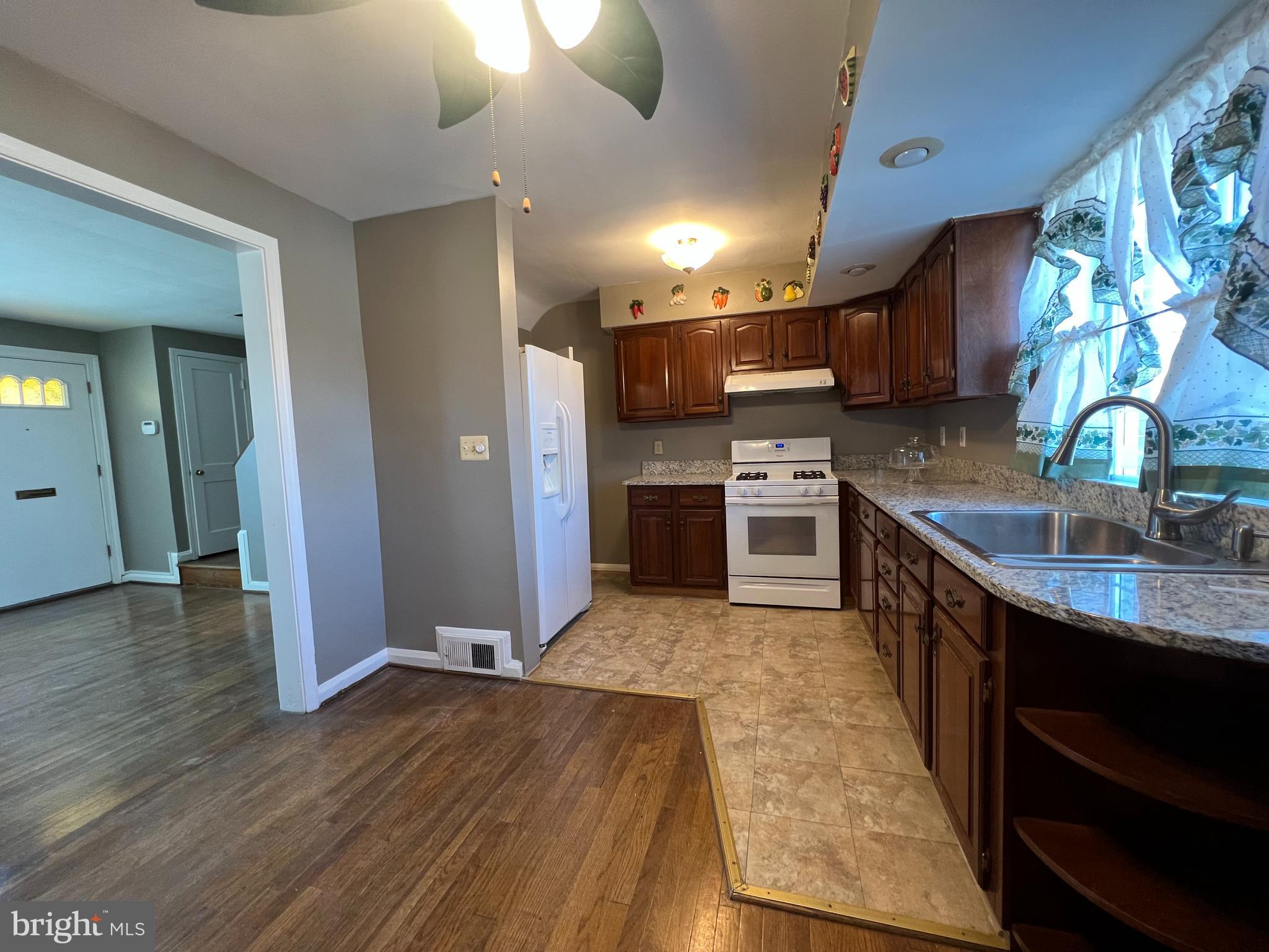 1006 Tunbridge Road Baltimore, MD 21212 - Photo 5 of 19 a kitchen with stainless steel appliances granite countertop a sink stove and refrigerator