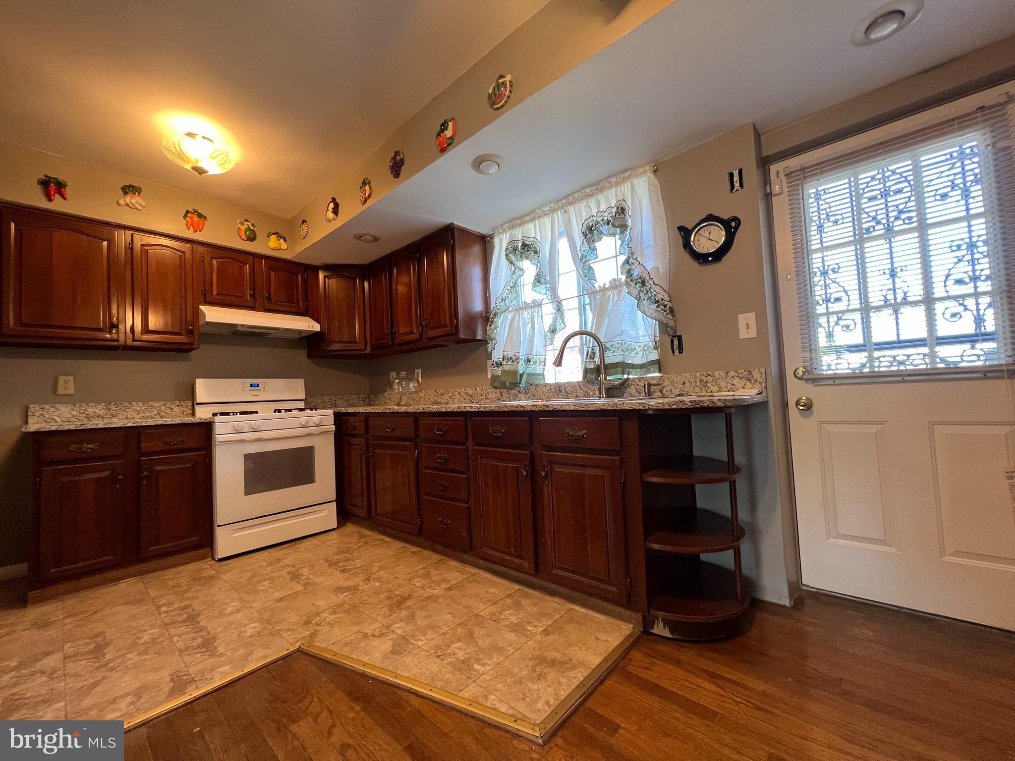 1006 Tunbridge Road Baltimore, MD 21212 - Photo 6 of 19 a kitchen with stainless steel appliances granite countertop a stove a sink and a microwave