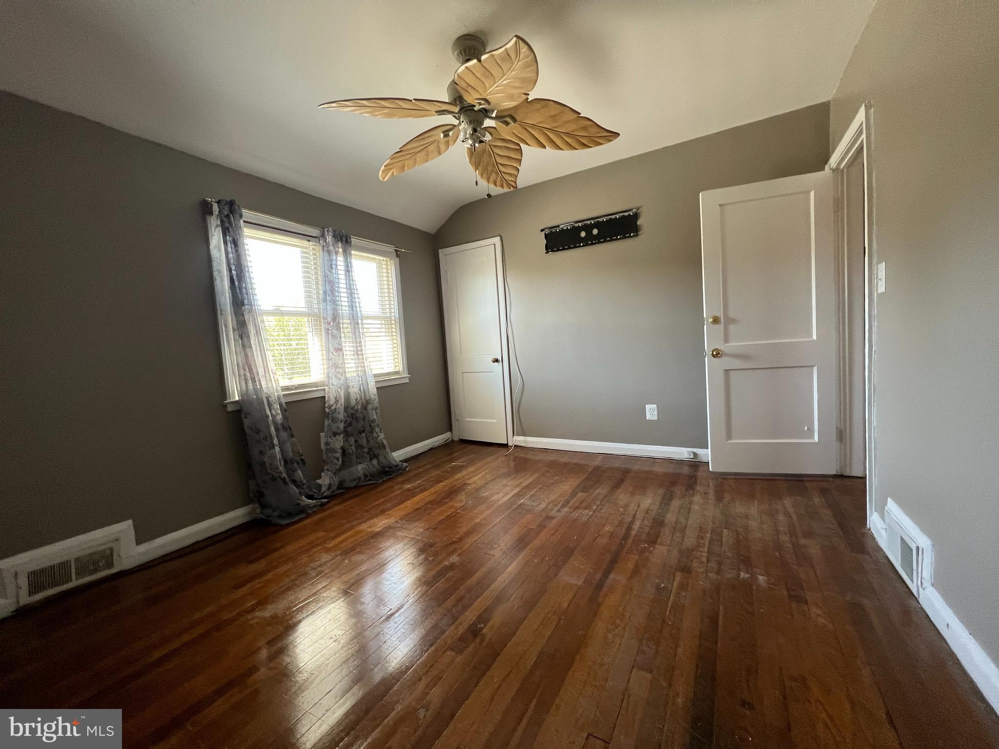 1006 Tunbridge Road Baltimore, MD 21212 - Photo 8 of 19 wooden floor in an empty room with a window
