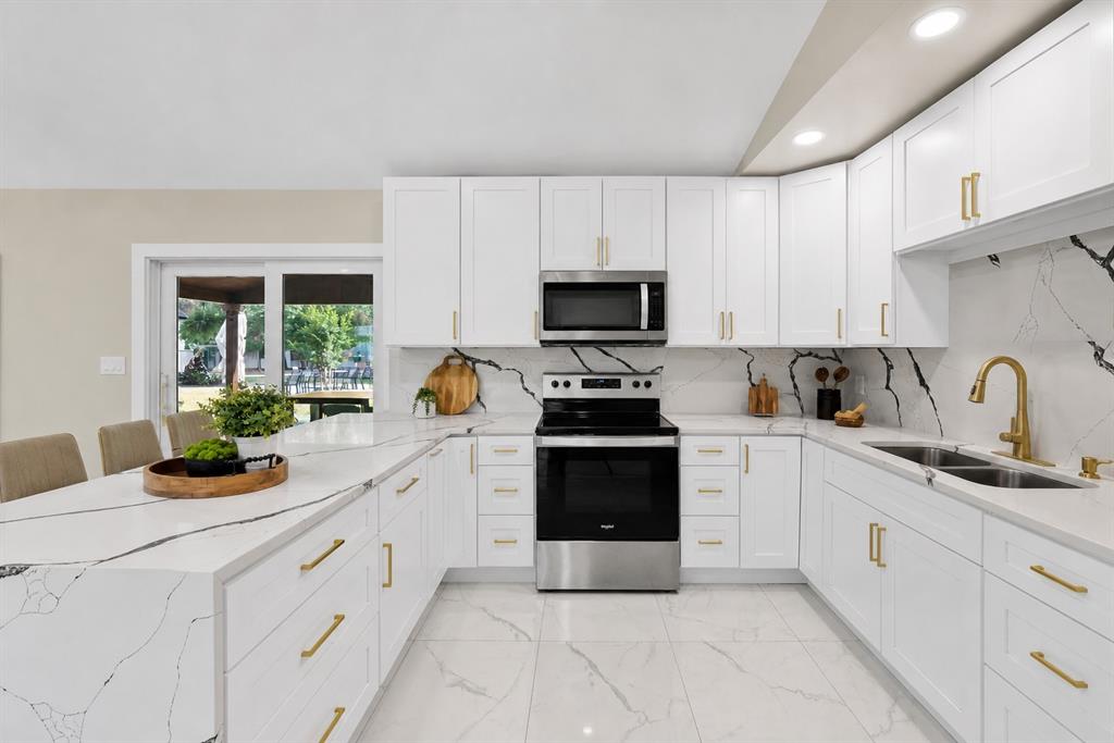620 East 6th Street Springtown, TX 76082 - Photo 6 of 40 a kitchen with white cabinets and appliances