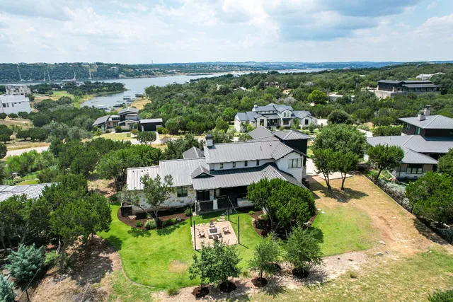 an aerial view of a house with yard and outdoor seating