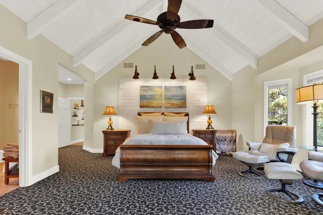 a living room with furniture ceiling fan and a window