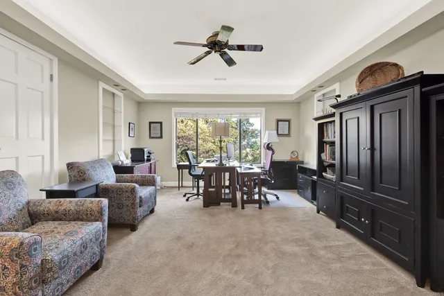a bedroom with a bed and a dresser next to a window