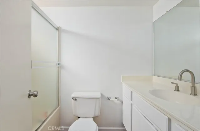 a bathroom with a toilet sink and shower